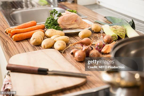 close-up of raw food on kitchen counter for chicken soup, munich, bavaria, germany - celery soup stock pictures, royalty-free photos & images