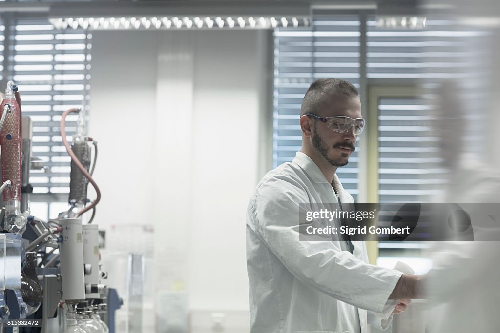 Young scientist working in a pharmacy lab, Freiburg im Breisgau, Baden-Württemberg, Germany