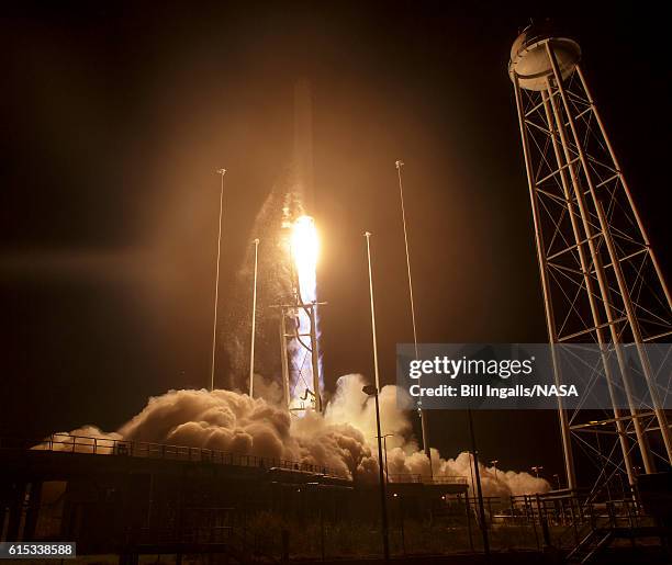 In this handout provided by NASA, the Orbital ATK Antares rocket, with the Cygnus spacecraft onboard, launches from Pad-0A at NASA's Wallops Flight...