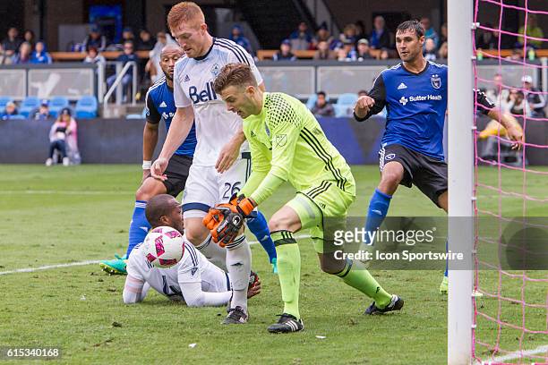Vancouver Whitecaps goalkeeper Paolo Tornaghi picks up a ball in front of his goal during the Major League Soccer game between the Vancouver...