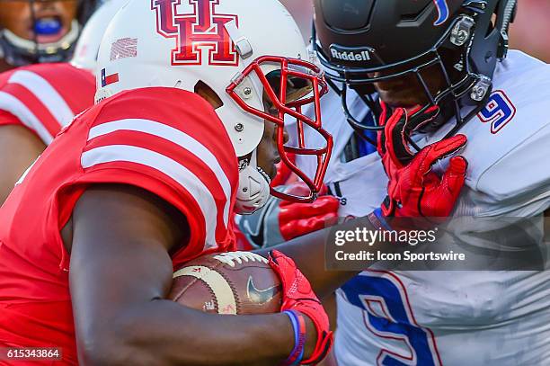 Houston Cougars running back Dillon Birden stiff arms Tulsa Golden Hurricane cornerback Reggie Robinson II during the Tulsa Golden Hurricanes at...