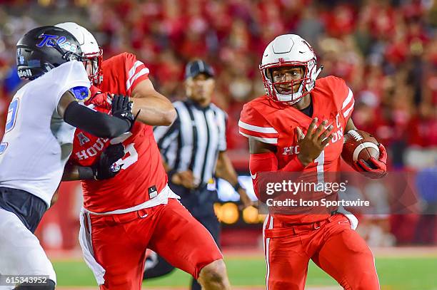 Houston Cougars quarterback Greg Ward Jr. Follows a block by Houston Cougars tight end Tyler McCloskey around the left end during the Tulsa Golden...