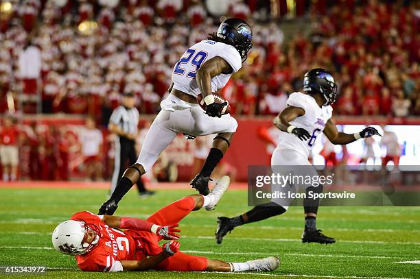 Tulsa Golden Hurricane wide receiver Justin Hobbs hurdles Houston Cougars linebacker Ralph Harvey Jr. During the Tulsa Golden Hurricanes at Houston...