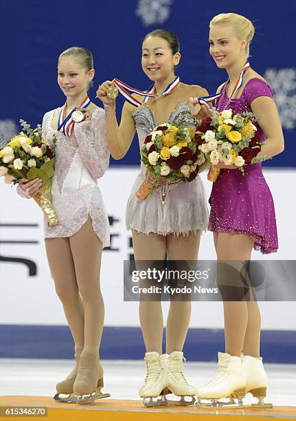 China - Julia Lipnitskaia of Russia, Mao Asada of Japan and Kiira Korpi of Finland hold their silver, gold and bronze medals during the award...