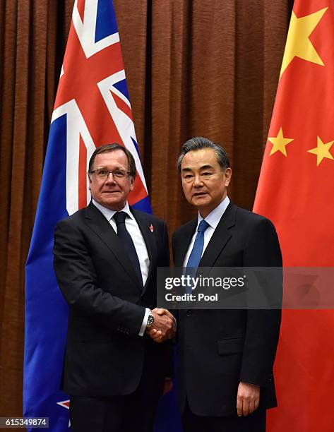 Murray McCully, Foreign Minister of New Zealand shakes hands with Wang Yi, Foreign Minister of China ahead of their meeting on October 18, 2016 in...