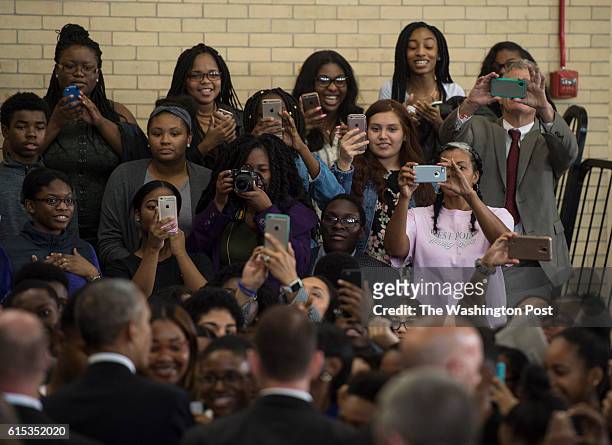 Students take photos of U.S. President Barack Obama following remarks at Benjamin Banneker Academic High School in Washington, D.C., on Monday,...