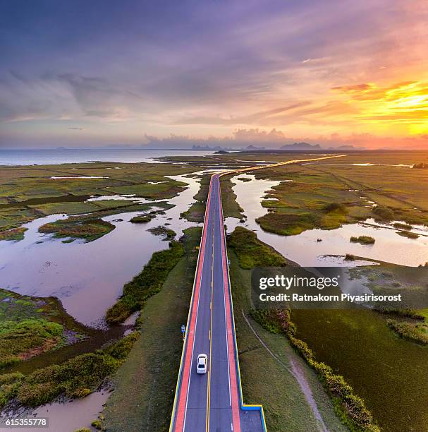 sunset scence of aerial view over the road - long river stock pictures, royalty-free photos & images