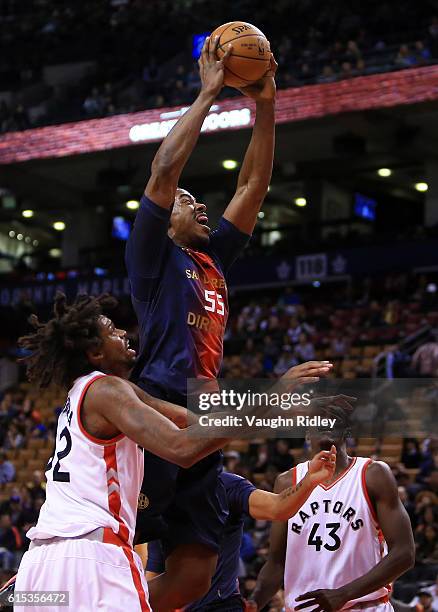 Jerome Meyinsse of San Lorenzo de Almagro drives to the basket as Lucas Nogueira of the Toronto Raptors defends during a NBA preseason game at Air...