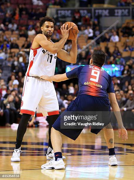 Drew Crawford of the Toronto Raptors passes the ball during a NBA preseason game against San Lorenzo de Almagro at Air Canada Centre on October 14,...