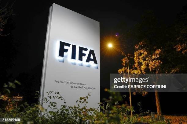Sign of the FIFA is seen at the entrance of the world football's governing body headquarters on October 13, 2016 in Zurich.