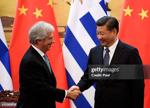 Uruguayan President Tabare Vazquez shakes hands with Chinese President Xi Jinping during a signing ceremony at the Great Hall of the People on...