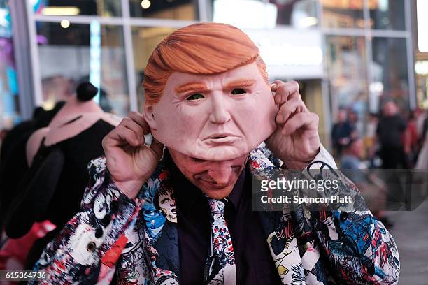 Times Square performer works in a Donald Trump mask on October 17, 2016 in New York City. As the nation prepares for the final debate between...