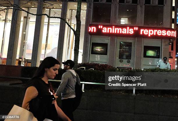 News ticker displays the latest stories from the campaign trail on October 17, 2016 in New York City. As the nation prepares for the final debate...