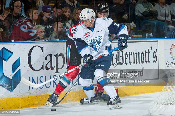 Jantzen Leslie of Saskatoon Blades checks Braydyn Chizen of Kelowna Rockets into the boards on October 14, 2016 at Prospera Place in Kelowna, British...