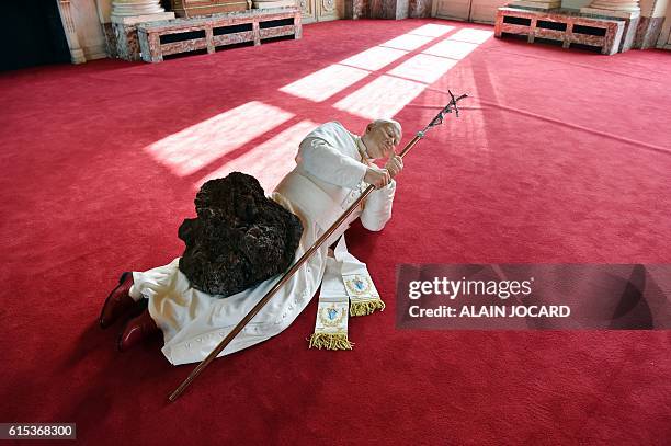 Picture taken on October 17 at the Monnaie de Paris museum shows a sculpture depicting Pope Jean Paul II "La Nona Ora" by Italian artist Maurizio...