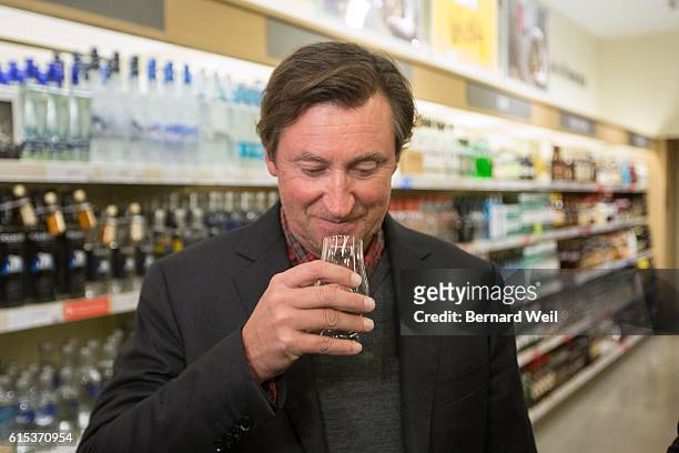 Wayne Gretzky sniffs a shot of his new No. 99 Canadian Whisky he launched at the Maple Leaf Square LCBO.
