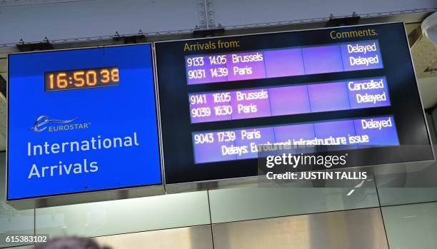 An electronic display board shows delayed Eurostar services in the International Departures area at the Eurostar terminal at London St Pancras train...