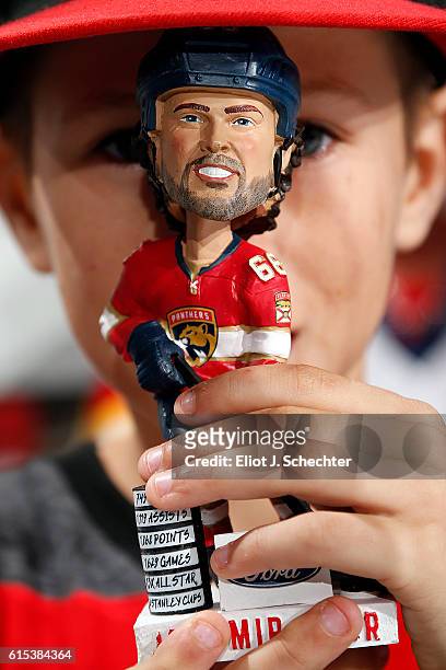 Fan holds a Jaromir Jagr of the Florida Panthers bobble head prior to the start of the game against the Detroit Red Wings at the BB&T Center on...