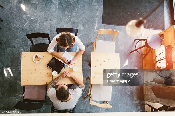 people sitting in cafe - coffee shop couple stock pictures, royalty-free photos & images