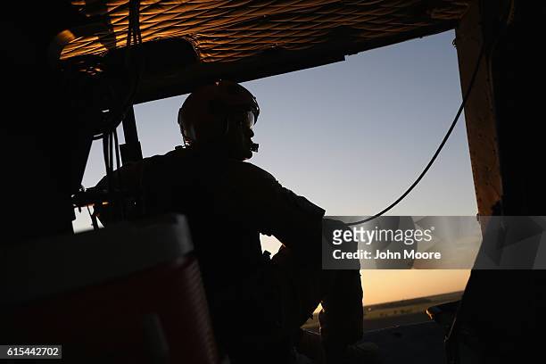 Customs and Border Protection agent scans the U.S.-Mexico border from a helicopter patrol on October 18, 2016 near McAllen, Texas. U.S. Air and...