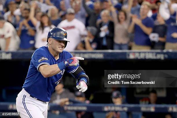 Josh Donaldson of the Toronto Blue Jays celebrates after hitting a solo home run in the third inning against Corey Kluber of the Cleveland Indians...