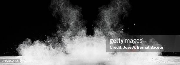 explosion particles of white powder on a black background - black smoke stock pictures, royalty-free photos & images