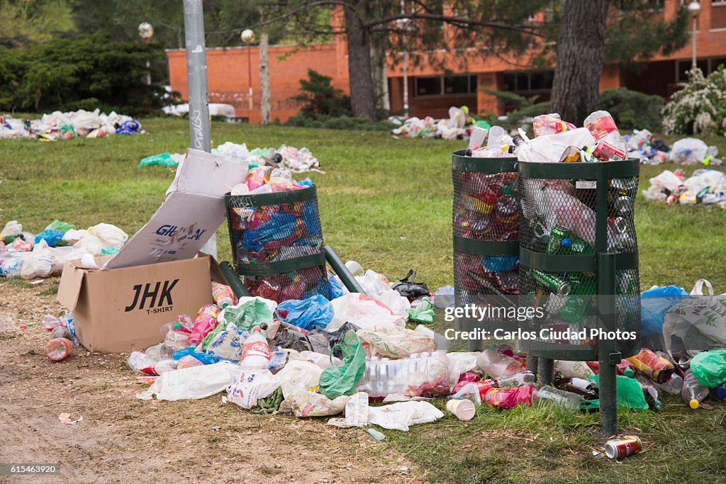 Overflowing bins in a park of Ciudad Universitaria, Madrid