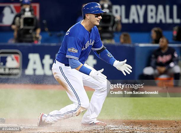 Troy Tulowitzki of the Toronto Blue Jays scores a run off of a single to center field hit by Ezequiel Carrera in the fourth inning against Corey...