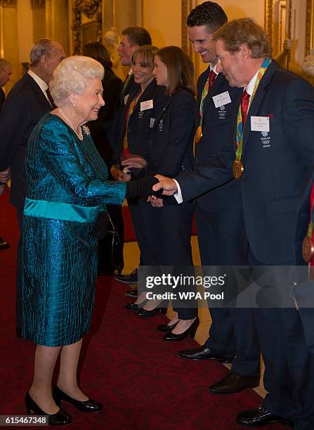 Queen Elizabeth II speaks with Nick Skelton at a reception for Team GB's 2016 Olympic and Paralympic teams at Buckingham Palace October 18, 2016 in...