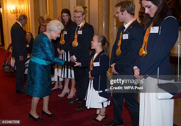 Queen Elizabeth II speaks with paralympians Ellie Simmonds, Jody Cundy and Sarah Storey at a reception for Team GB's 2016 Olympic and Paralympic...