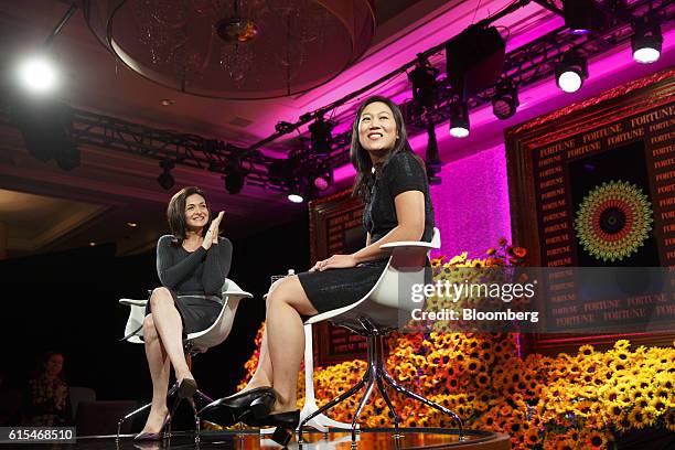 Sheryl Sandberg, chief operating officer of Facebook Inc., left, applauds as Priscilla Chan, co-founder of the Chan Zuckerberg Initiative LLC, smiles...