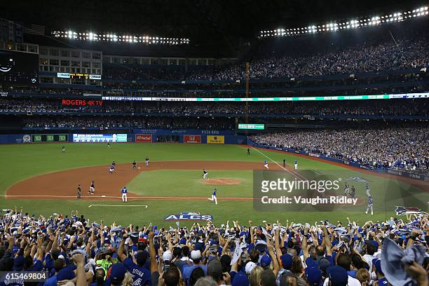 Jose Bautista and Ryan Goins of the Toronto Blue Jays score off of an RBI double hit by Edwin Encarnacion in the seventh inning against Bryan Shaw of...