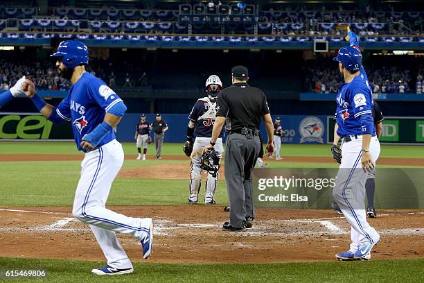 Jose Bautista and Ryan Goins of the Toronto Blue Jays score off of an RBI double hit by Edwin Encarnacion in the seventh inning against Bryan Shaw of...
