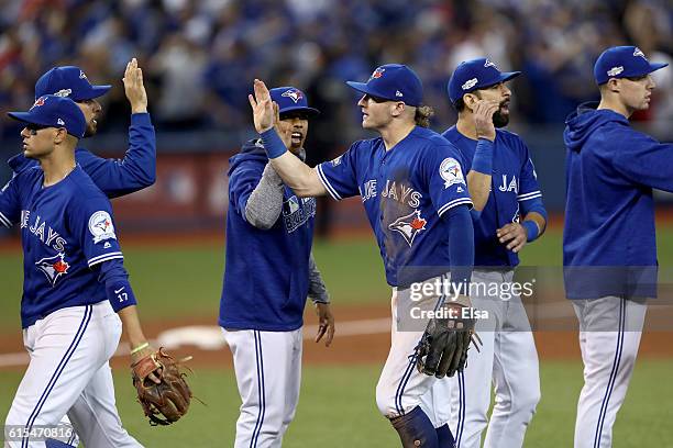 Josh Donaldson of the Toronto Blue Jays celebrates with his teammates after defeating the Cleveland Indians with a score of 5 to 1 in game four of...
