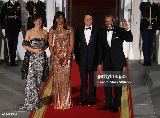 President Barack Obama and first lady Michelle Obama stand with Italian Prime Minister Matteo Renzi and his wife Mrs. Agnese Landini upon arrival for...