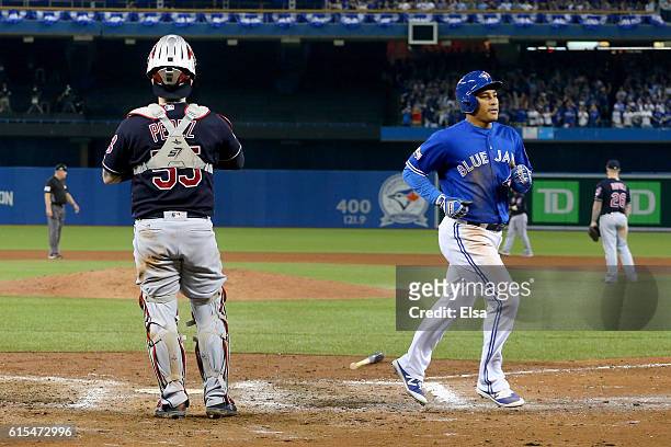 Ezequiel Carrera of the Toronto Blue Jays scores a run off of a sacrifice fly to right field hit by Kevin Pillar in the eighth inning against Mike...