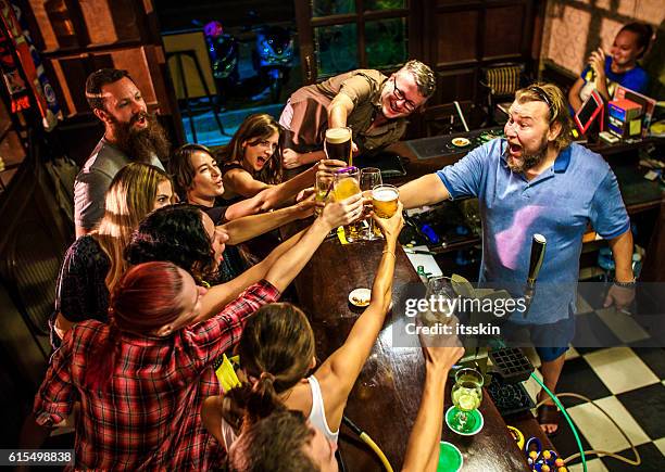friends partying in the bar - beautiful irish person stockfoto's en -beelden