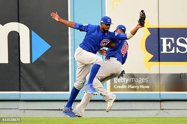 Dexter Fowler of the Chicago Cubs catches a fly ball and then crashes into teammate Jorge Soler in the second inning in game three of the National...