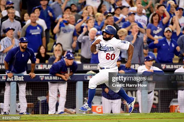 Andrew Toles of the Los Angeles Dodgers rounds third to score a run in the third inning on a hit by Corey Seager against the Chicago Cubs in game...