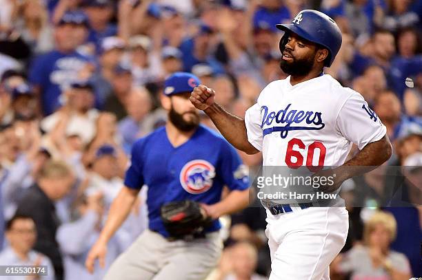 Andrew Toles of the Los Angeles Dodgers scores a run in the third inning on a hit by Corey Seager against the Chicago Cubs in game three of the...