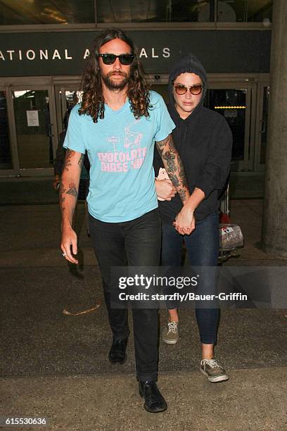 Kesha and Brad Ashenfelter are seen at LAX on October 18, 2016 in Los Angeles, California.