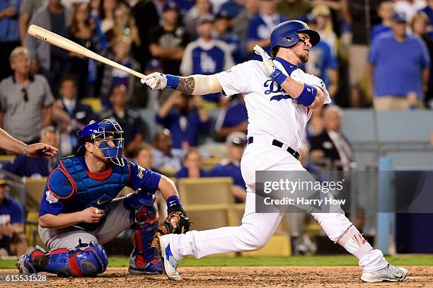 Yasmani Grandal of the Los Angeles Dodgers hits a two-run home run in the fourth inning against the Chicago Cubs in game three of the National League...