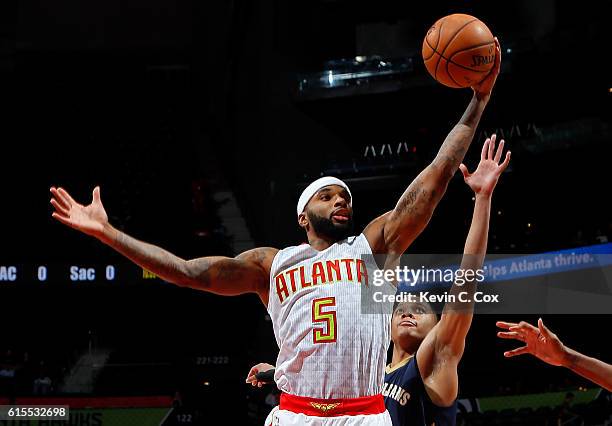 Malcolm Delaney of the Atlanta Hawks grabs a rebound against Tim Frazier of the New Orleans Pelicans at Philips Arena on October 18, 2016 in Atlanta,...