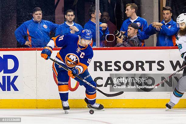 New York Islanders Center John Tavares with the puck against the boards during the first period of a NHL game between the San Jose Sharks and the New...