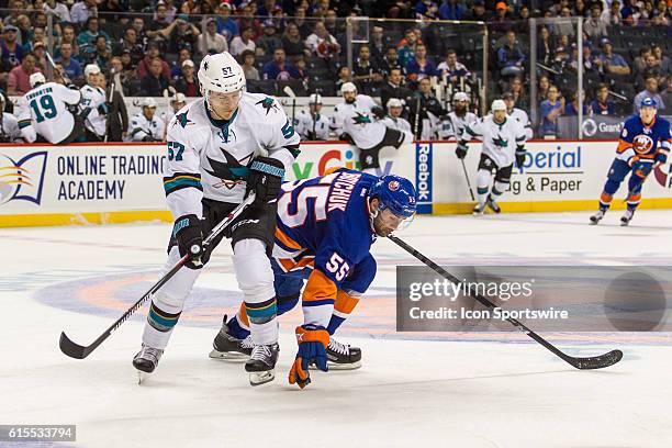 New York Islanders Denfenseman Johnny Boychuk reaches down and blocks a pass to San Jose Sharks Center Tommy Wingels during the first period of a NHL...