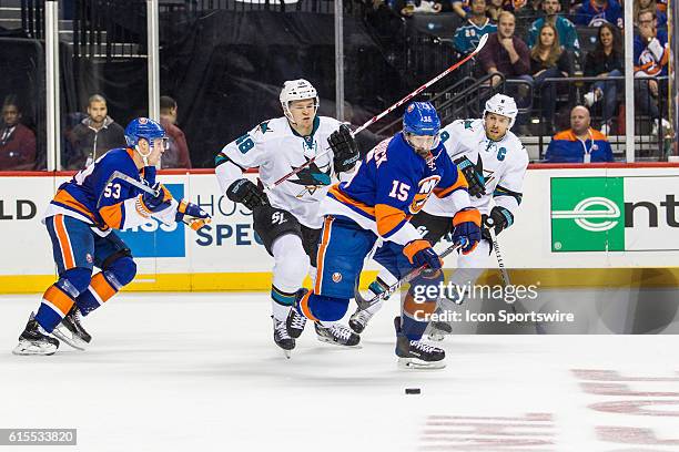 New York Islanders Right Wing Cal Clutterbuck works to clear the puck out of the Islanders zone during the first period of a NHL game between the San...