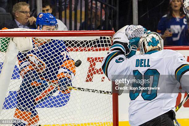 New York Islanders Left Wing Anthony Beauvillier peers through the net to see the puck slip past San Jose Sharks Goalie Aaron Dell , scoring his...