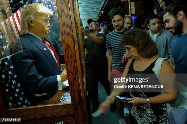 People view the art installation "All-Seeing Trump", a fortune telling machine created by a group of anonymous Brooklyn-based artists, is seen...