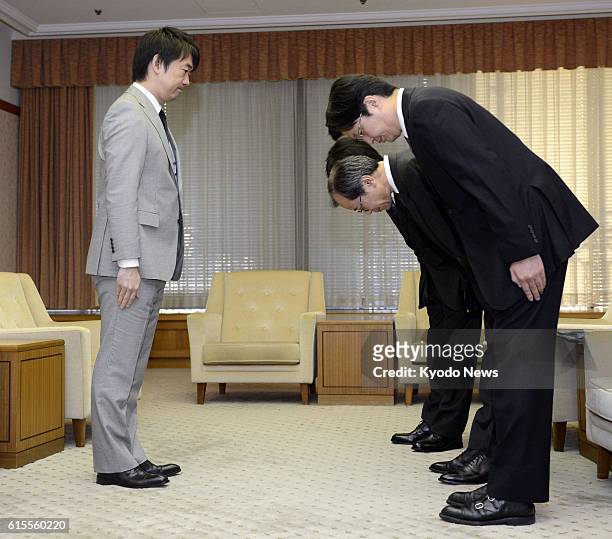 Japan - Officials of Asahi Shimbun Publications Inc. Bow in apology to Osaka Mayor Toru Hashimoto at the Osaka city hall on Nov. 12 over an article...