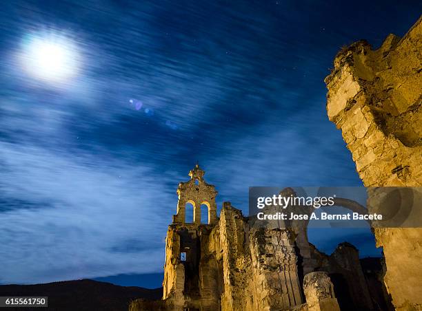 ruins of  abandoned convent one night with blue sky and the full moon - bruges night stock pictures, royalty-free photos & images